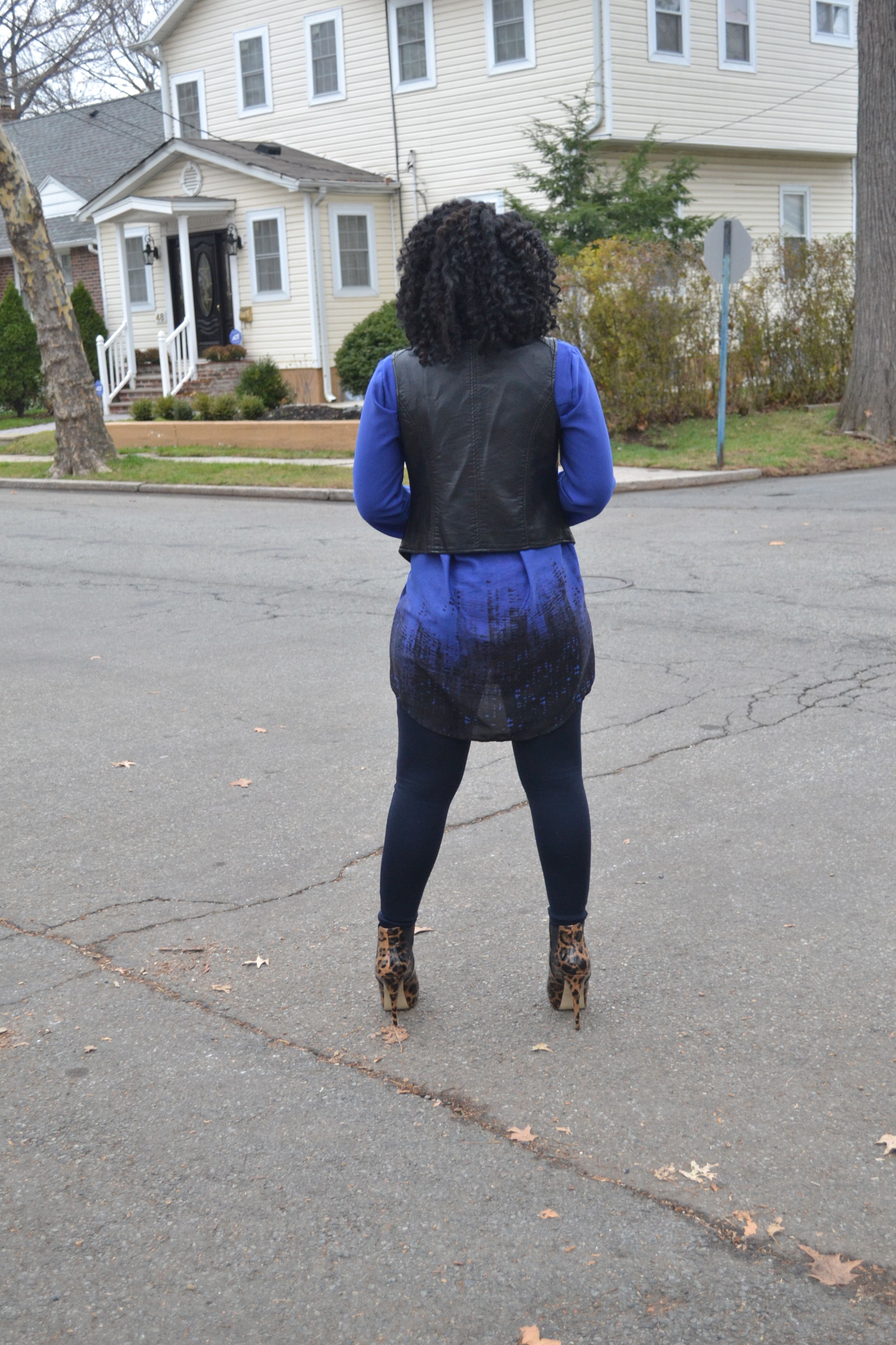 Black leather vest and blue leggings